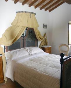 a bedroom with a large bed with a canopy at Agriturismo La Tana Del Lupo in Cantalupo
