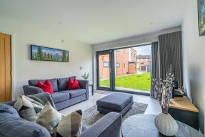 a living room with a blue couch and red pillows at Garden View in York