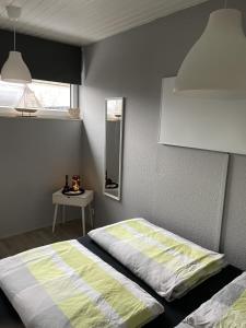 a bedroom with a bed and a table and a mirror at Friesische Freiheit in Butjadingen OT Tossens