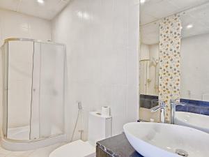 a bathroom with a tub and a toilet and a sink at MK Residence JVC in Dubai