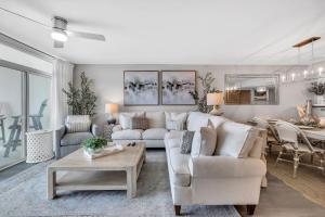a living room with a couch and a table at All New Oceanfront Luxury w Lazy River in Myrtle Beach
