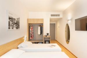 Postel nebo postele na pokoji v ubytování Victor Hotel