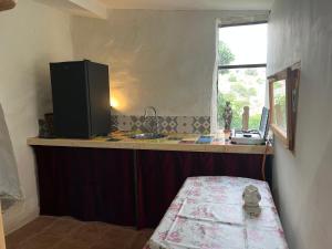 a kitchen with a counter with a sink and a window at Chateau Fitou Presbytery in Fitou +9 photos