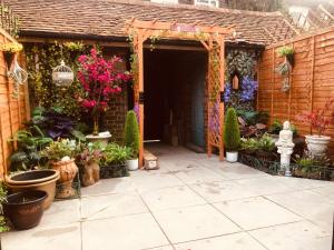 a garden entrance to a house with potted plants at London Central 4 bed House with Garden in London