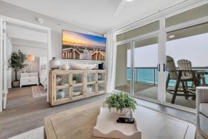 a living room with a view of the ocean at All New Oceanfront Luxury w Lazy River in Myrtle Beach