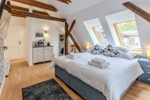 a bedroom with a large bed in a room at Fulop Panzio Rooms in Révfülöp