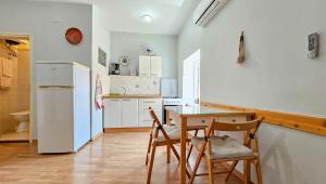 a kitchen with a table and chairs and a refrigerator at Margarita 2 in Novigrad Istria +21 photos
