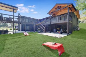 a house with a red bench in the yard at Stay And Play 18 Guest Family Fun - Pickleball Court in Sevierville