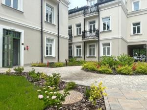 a building with a garden in front of it at Like-a House Stare Miasto in Płock
