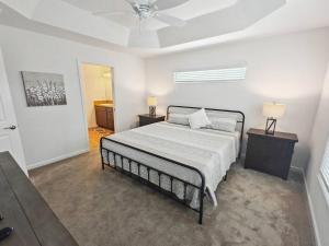 a bedroom with a bed with two night stands and two lamps at Charming Courtyard Villa In The Villages in Wildwood +19 photos