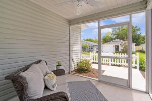 a porch with a couch and a sliding glass door at Luxurious 2 Bedroom Villa in The Villages