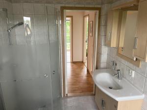 a bathroom with a shower and a sink at Holiday Home 36A BÅSTAD in Båstad +22 photos