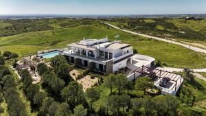 an aerial view of a large house with a pool at La Glycine in Castro Marim