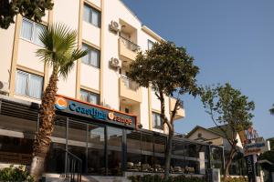 a building with a leasing agency sign in front of it at Coastline Orange Hotel in Antalya