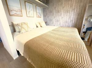 a bedroom with a large bed with a large bedspread at Ocean Front! New Built Apartment! SOU Resort YAKA in Kin