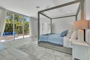 a bedroom with a large bed with a large mirror at Equestrian Stay, Heated Pool, Game Room, Fire Pit in Loxahatchee +43 photos