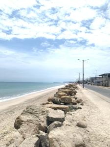 a beach with rocks on the side of a road at La Casita del Sol in Crucita