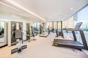 a gym with cardio equipment in a building at Stylish Family 1BR with Cozy Bunks and Games for 5 in Sydney