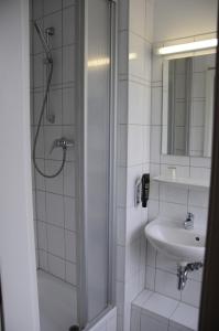 a bathroom with a shower and a sink at Potsdamer Inn in Berlin