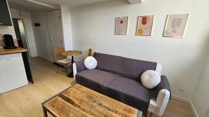 a living room with a couch and a table at Le Naturel, Cocon Calme au Centre-ville in Montargis +15 photos