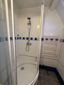 a bathroom with a shower with a glass door at Cottage with Garden 5mn Beach in Cabourg +22 photos