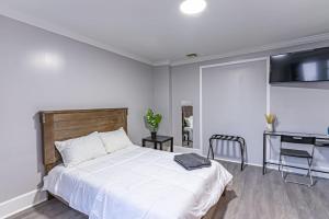 a bedroom with a white bed and a desk at Private BR Trains EWR USA Mall Penn Station in Newark