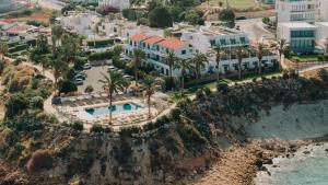 an aerial view of a resort next to the ocean at Vrachia Beach Hotel & Suites - Adults Only in Paphos