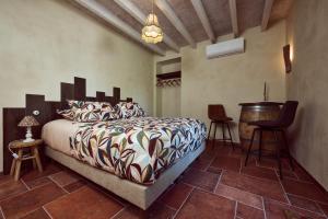 a bedroom with a bed and a table and chairs at La Ferme de Jeanne in Francescas +46 photos