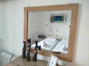 a mirror reflecting a bed in a bedroom at Iliahtides in Kala Nera +76 photos
