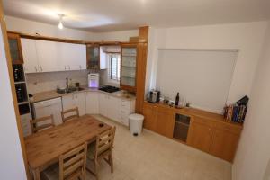 a kitchen with a wooden table and a counter top at Vacation rental in Netanya