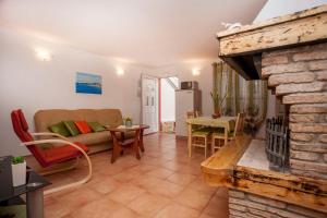 a living room with a couch and a fireplace at Casa Terren Grande in Rovinj