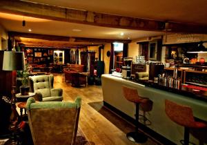 a bar in a pub with a counter and chairs at De Pingerhoeve in Nuth