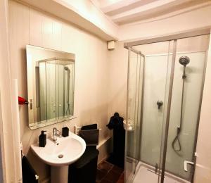 a bathroom with a sink and a glass shower at La Signature - Appt 70m² pour 6 voyageurs in Bayeux