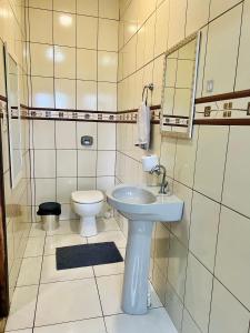 a small bathroom with a sink and a toilet at Pôr-do-Sol Pousada in Penha +47 photos