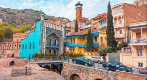 a group of buildings in a city with cars parked at Abanotubani apartment in Tbilisi City