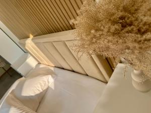 a room with a bed and a potted plant at Baltic Avenue Duo in Klaipėda