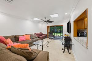 a living room with a couch and a table at Luxury Queen Room, Free Car Service, Walk to UM! in Miami