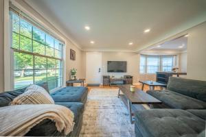 a living room with a couch and a table at Newly Renovated Townhouse on a Tranquil Street in Dearborn