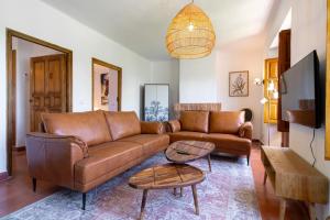 a living room with a brown leather couch at Villa Lorca Vista Mar by Casasol in Nerja