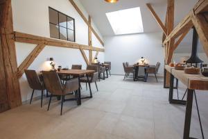 a dining room with wooden tables and chairs at Hors du Temps Malbuisson in Malbuisson