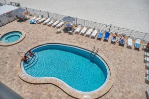 an overhead view of a swimming pool with people sitting around it at Sandcastle III Condo 404 in Clearwater Beach