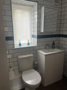 bagno bianco con servizi igienici e finestra di Dog Friendly Cottage with 3 double bedrooms ad Airton Altre 20 foto