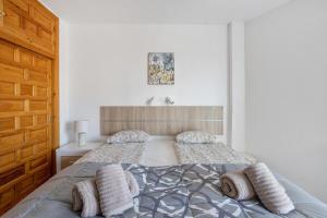 a bedroom with a bed with two pillows on it at A410 Frontlilne Apartment in Nerja +12 photos