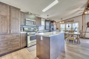 a kitchen with stainless steel appliances and a table at The Lakeside Shack on West Lake Okoboji in Spirit Lake