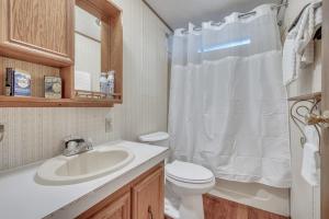 a bathroom with a toilet and a sink at The Lakeside Shack on West Lake Okoboji in Spirit Lake +26 photos