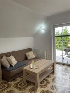 a living room with a couch and a coffee table at Pokoje gościnne KOGA in Nickelswalde