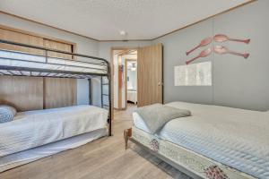 a bedroom with two bunk beds next to each other at The Lakeside Shack on West Lake Okoboji in Spirit Lake