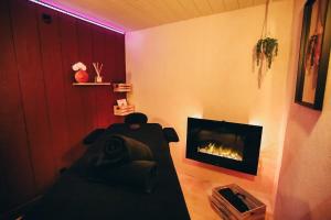 a living room with a couch and a fireplace at Love Room L'Entre Nous in Thairé