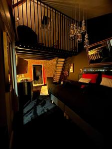 a living room with a couch and a staircase at Love Room L'Entre Nous in Thairé