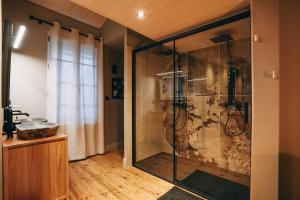 a large shower in a bathroom with a sink at Love Room L'Entre Nous in Thairé +51 photos